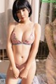 A woman in a pink lingerie posing in front of a mirror.